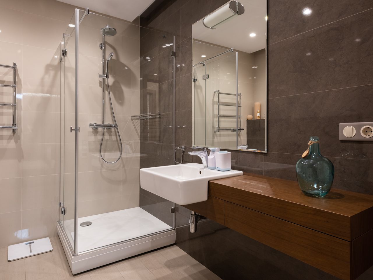 Luxurious contemporary bathroom featuring glass shower and sleek minimal design.